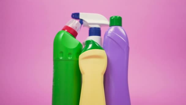 Four bottles of cleaning detergent. Green, yellow, and purple jar. — ストック動画