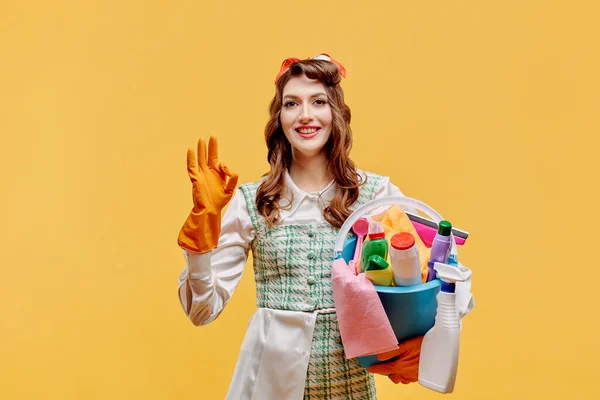 The cleaning lady makes an OK gesture and looks at the camera. Pin-up style. Royalty Free Stock Images