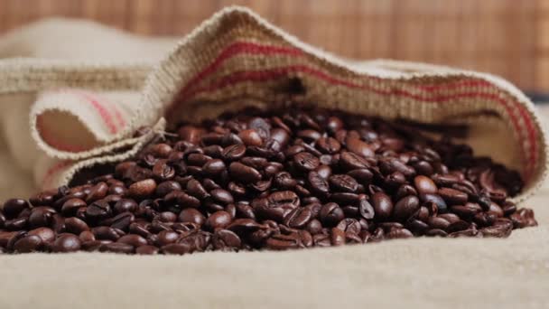 Close-up of dark black roasted coffee beans. An ingredient for making coffee. — Stock Video
