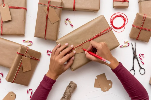 Female Hands Writing Christmas Cards Gift Boxes Decorated Kraft Paper — Stock Photo, Image