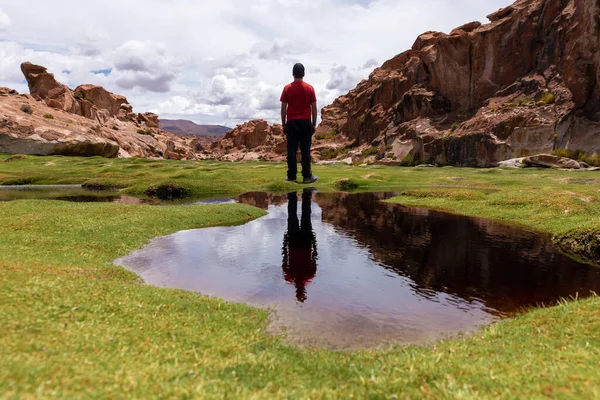 Reflection of a man in a scenic lake in the southwest of the Bolivian altiplano