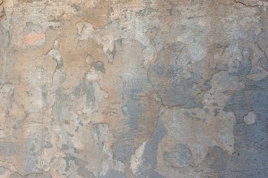 Evin sokak duvarında eski kahverengi alçı dokusu var. Sıcak gölgeler Eski Duvar dokusu