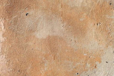 Evin sokak duvarında eski kahverengi alçı dokusu var. Sıcak gölgeler Eski Duvar dokusu