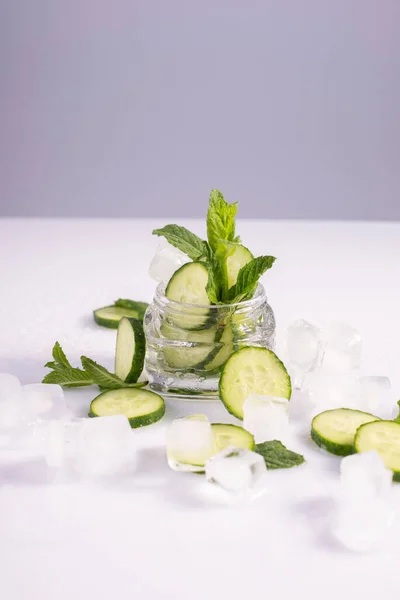 moisturizing cosmetics based on natural extracts of aloe, cucumber and ice in a glass container on a white background.
