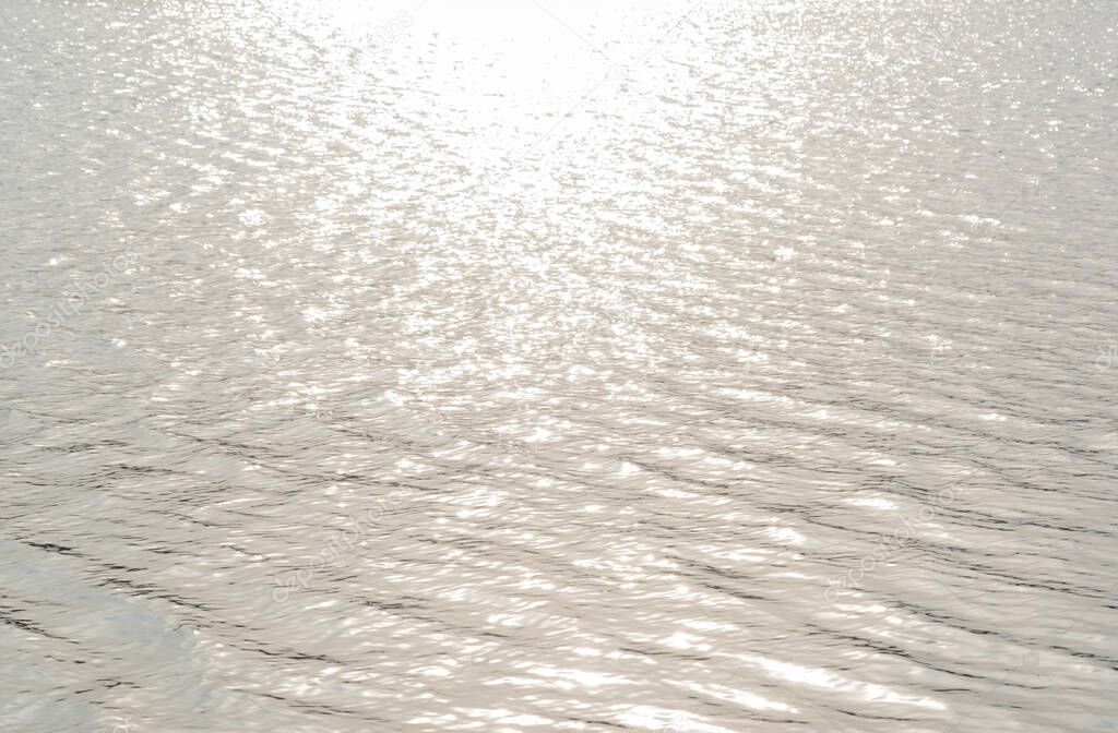 solar reflex on the water during the day. River water texture.