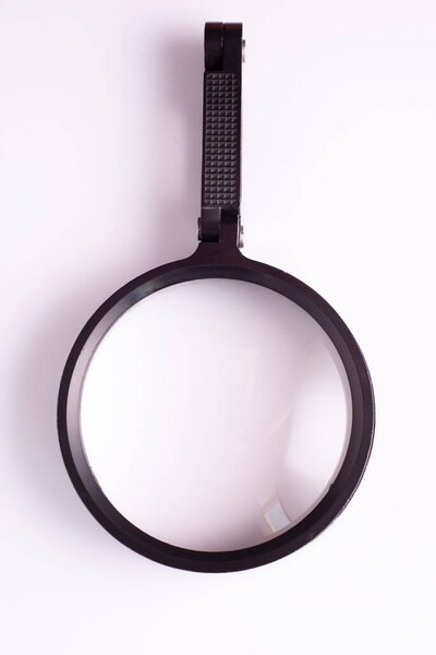Old magnifying glass on white background, loupe.