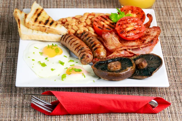 Pequeno-almoço inglês completo com bacon, salsicha, ovo, feijão e cogumelos — Fotografia de Stock