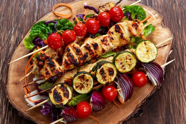 Chicken kebab with vegetables grilled on BBQ.