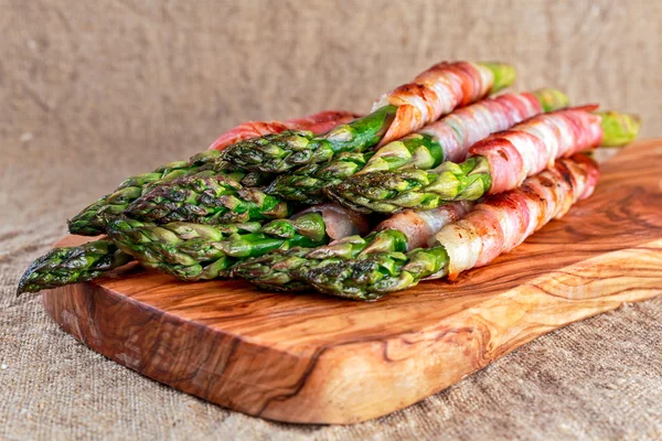 Bacon Wrapped Asparagus on wooden desk — Stock Photo, Image