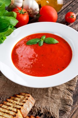 Yumuşak ve tatlı domates çorbası, fesleğen ile terbiyeli sarımsak.