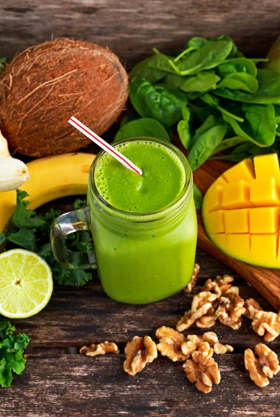 Friska gröna nå vitaminer Smoothie med baby leaf spenat, grönkål, mango, banan, lime, valnöt och kokos vatten. — Stockfoto