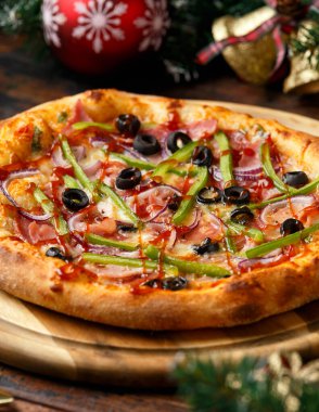 Noel Mangalı Pizza, dekorasyon, hediyeler, ahşap kırsal masada yeşil ağaç dalı..