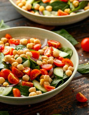 Domatesli nohut salatası, salatalık, kırmızı soğan ve yeşillik. Beslenme yemeği. Vegan salatası.