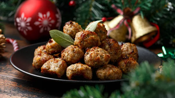 Christmas Pork stuffing meatballs with sage and onion. decoration, gifts, green tree branch on wooden rustic table — Stock Photo, Image