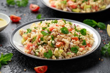 Domates, salatalık, kırmızı soğan, bulgur ve maydanozlu Tabbouleh salatası. Sağlıklı vejetaryen yemekleri