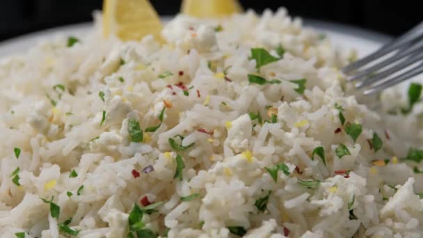 Picking up with fork Greek feta cheese Rice with lemon zest and herbs. — Stock Video
