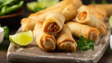 Kızarmış sebzeli börek ve ahşap tahtada soya sosu.