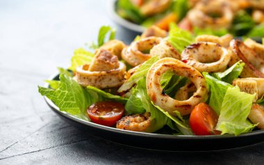 Izgara kalamar ya da kalamar ve karides salatası sarımsaklı ekmek ve vişneli domates.