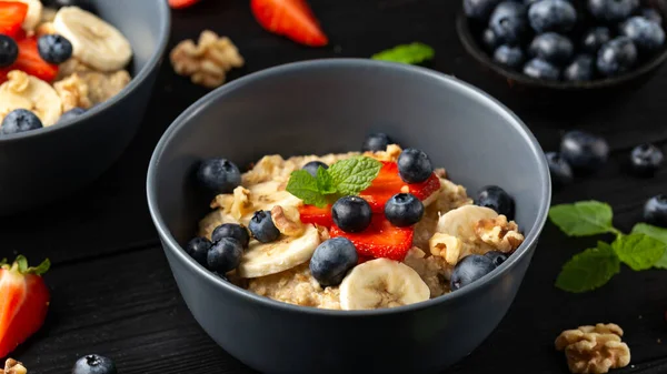 Gachas de avena saludable desayuno con fresa, arándanos, plátano y miel —  Fotos de Stock