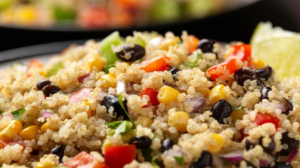 Quinoa black bean salad with corn, red green pepper, onion. Healthy food.