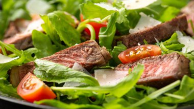 İtalyan biftekli Tagliata salatası, yaban roketi, vişneli domates ve parmesan peyniri.