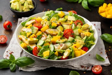 Avokado, salatalık, vişneli domatesli tavuk mango salatası. Sağlıklı yemek.