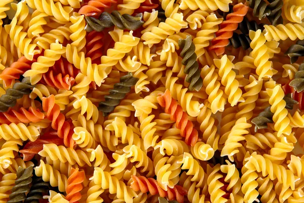 Traditional Italian fusilli tricocolore close up. Background, texture — ストック写真