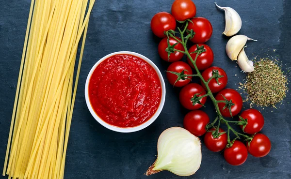 Ingredients for Spaghetti with marinara sauce.  Ready to Cook. On blue background — Stock Photo, Image