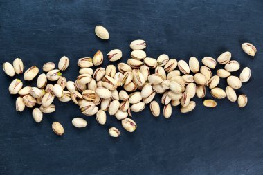 Fresh Salt Pistachios  on blue stone Background