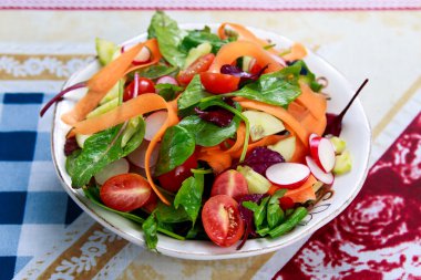 Eski ahşap masa üzerinde taze sebze salatası.