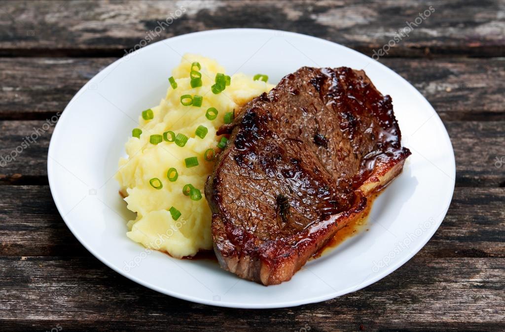 Rare beef steak with mashed potatoes