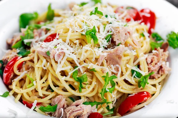 Close up Italian Tuna Pasta spaghetti with tomato, chilli, parmesan and wild rocket  lives.