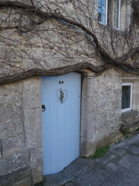 Uma casa de pedra velha elegante com uma porta azul clara — Fotografia de Stock