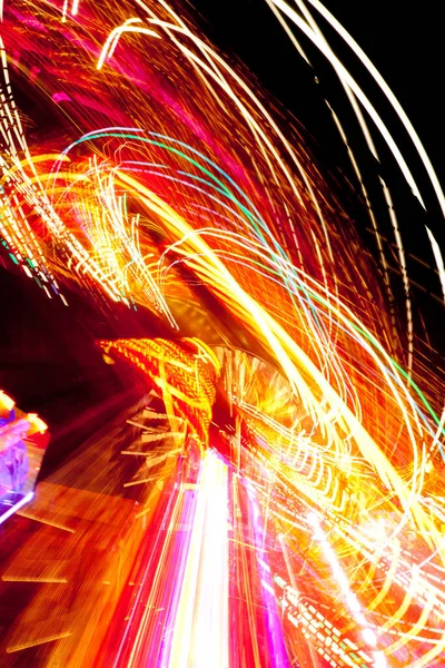 An abstract swirl of neon lights at night — Stock Photo, Image
