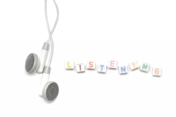 White earbuds with alphabet listening — Stock Photo, Image