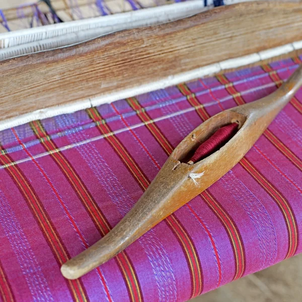 wooden bobbin on ancient silk loom