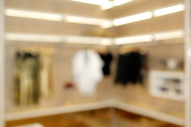 blurred wide dressing room with wardrobe in modern house as background