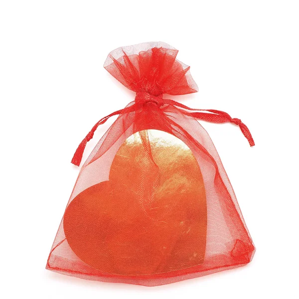 Golden heart in red pouch — Stock Photo, Image