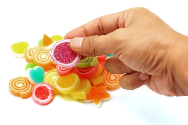 Mano umana raccogliere caramelle caramella gelatina dolce — Foto Stock