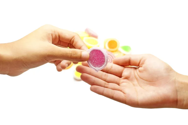 Human hand pick up jelly sweet candy isolated on white — Stock Photo, Image