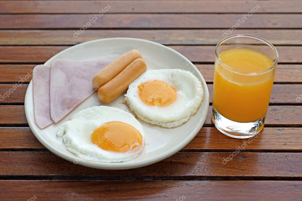 Breakfast meal with ham sausage egg and orange juice — Stock Photo