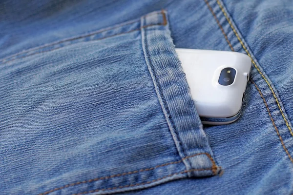 mobile smart phone in pocket blue jeans