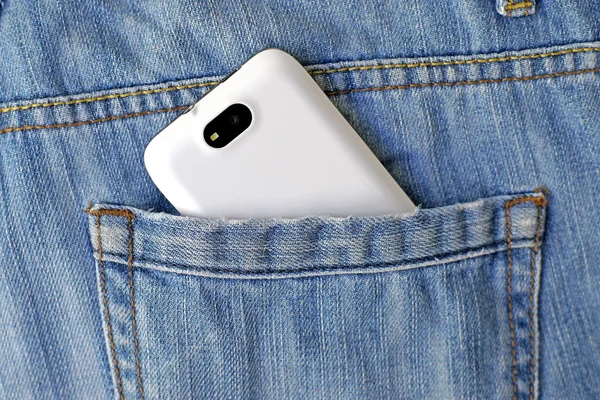 mobile smart phone in pocket blue jeans