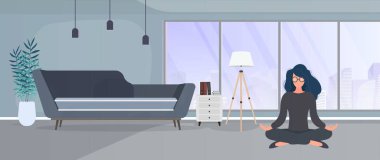 Elinde kedisiyle kanepede oturan bir kadın.