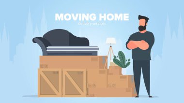 Adam hareket ediyor. Bir adam elinde bir yığın kutuyla duruyor.