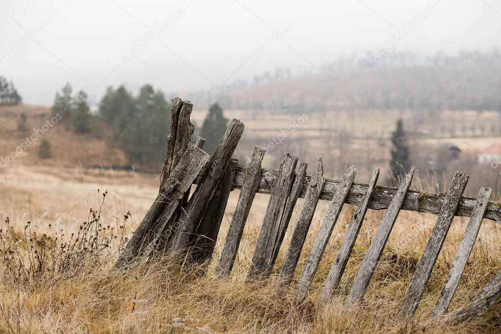 Rustic fence in the countryside on foggy morning