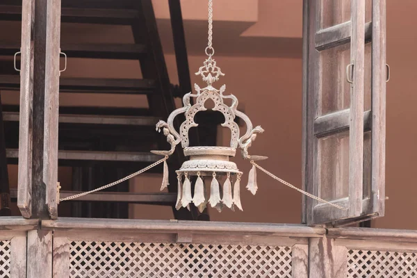 Hanging Panas(Hanging oil lamp) is hanged outside the window to mostly decorate the house as well as it is a means of praying to the god in Nepal