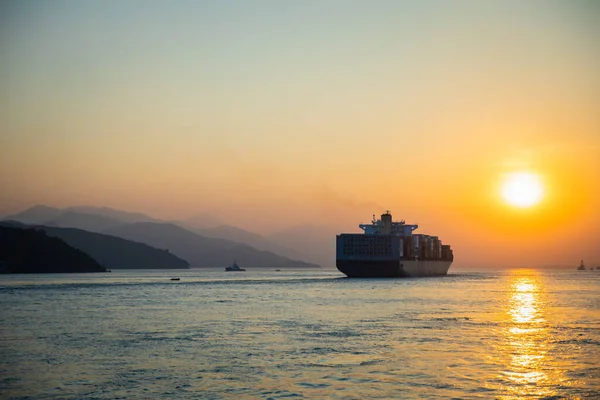 Cargo Carrier sailing in ocean, sunset moment, Hong Kong