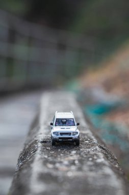 Çitin üzerinde minyatür bir SUV arabası. Makro fotoğrafçılık.