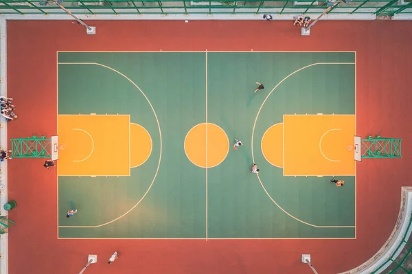 aerial top view of the public basketball court in Hong Kong, Children playing outdoor